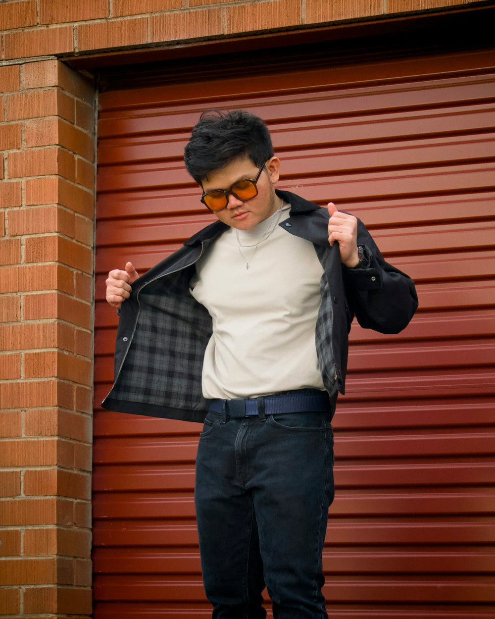 Street-style portrait with a jacket and yellow sunglasses by Irham Setyaki. Style inspiration, not a product listing.